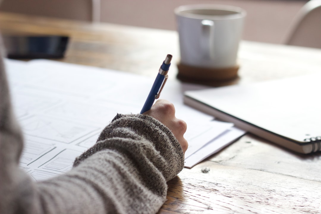 Student planning a nursing dissertation and reviewing research notes