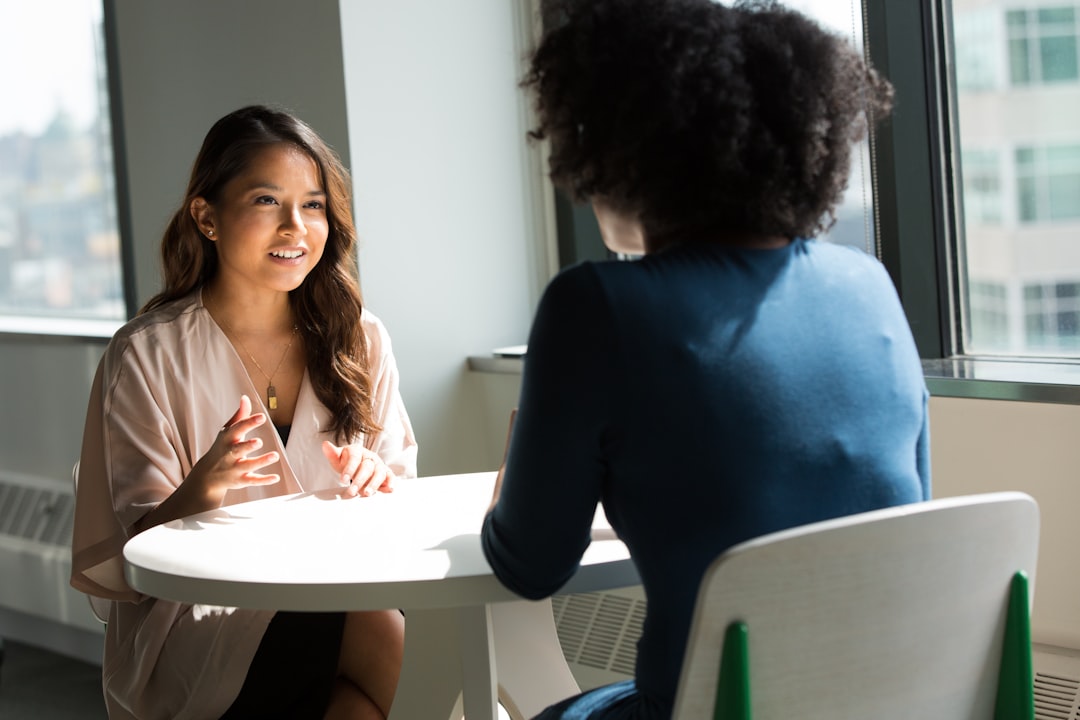Two people discussing a qualitative research interview
