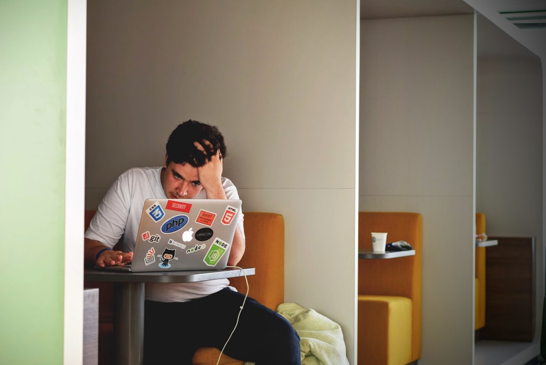 Nursing student concentrating on a university assignment beside a laptop and notebook
